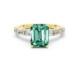 Yellow gold Emerald Cut Green Sapphire Solitaire with Side Baguettes and Channel Set Band