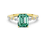 Yellow gold Emerald Cut Green Sapphire Solitaire with Side Stones on a Pavé Band and Four-Prong Setting