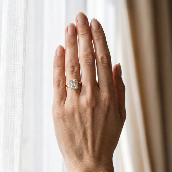 Yellow gold Emerald Cut Halo Solitaire Ring with Channel Band and Four-Prong Setting