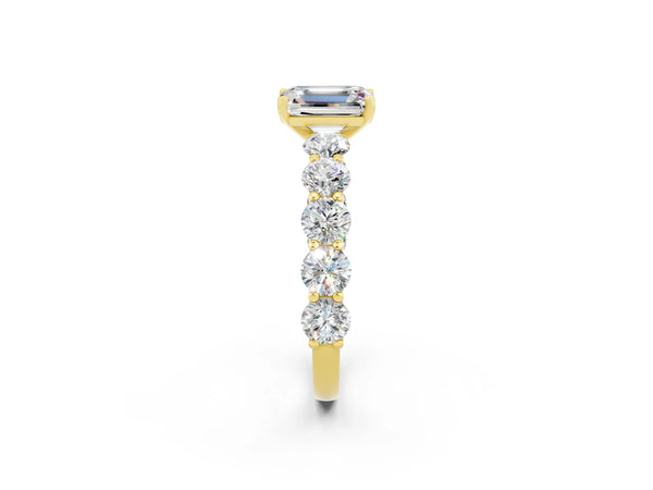 Yellow gold Emerald Cut Moissanite Prong Setting with Side Stones on a Pave Band
