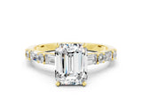 Yellow gold Emerald Cut Moissanite Solitaire with Side Baguettes and Channel Set Band