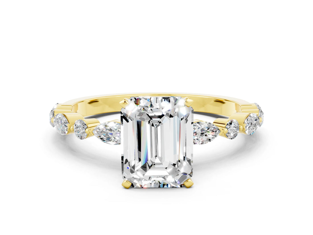 Yellow gold Emerald Cut Moissanite Solitaire with Side Stones on a Pavé Band and Four-Prong Setting