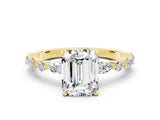 Yellow gold Emerald Cut Moissanite Solitaire with Side Stones on a Pavé Band and Four-Prong Setting