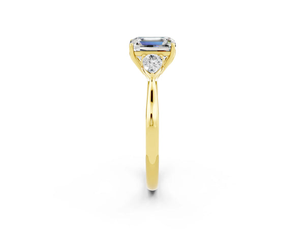 Yellow gold Emerald Cut Moissanite Three-Stone Ring with Pear  Side Stones and Prong Setting