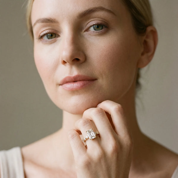 Yellow gold Emerald Cut Solitaire Diamond Ring with Pave Band and Four-Prong Setting