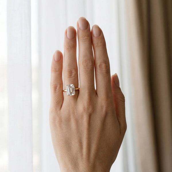 Yellow gold Emerald Cut Solitaire Engagement Ring with Four-Prong Setting and Classic Band