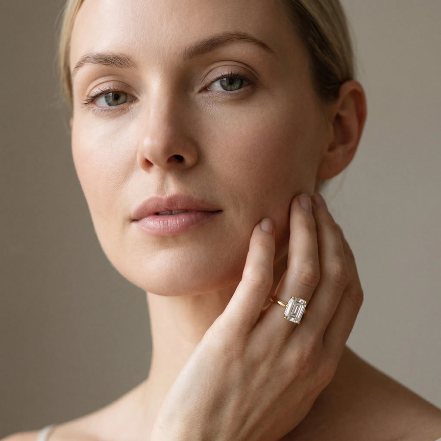 Yellow gold Emerald Cut Solitaire Engagement Ring with Four-Prong Setting and Classic Band