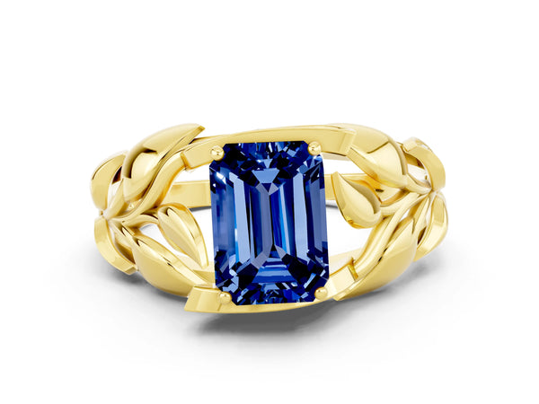 Yellow gold Emerald Cut Blue Sapphire Leaf-Inspired Engagement Ring with Round Accents and Prong Setting