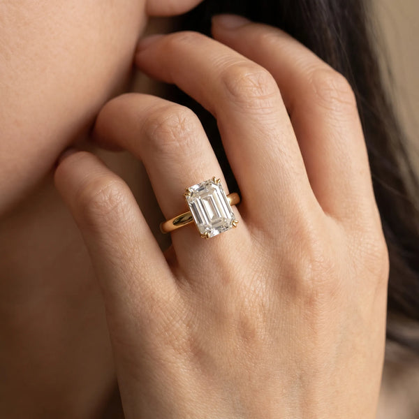 Yellow gold Emerald Cut Solitaire Ring with Four-Prong Setting and Classic Band