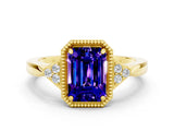 Yellow gold Emerald Cut Tanzanite Halo Ring with Tapered Band and Four-Prong Setting