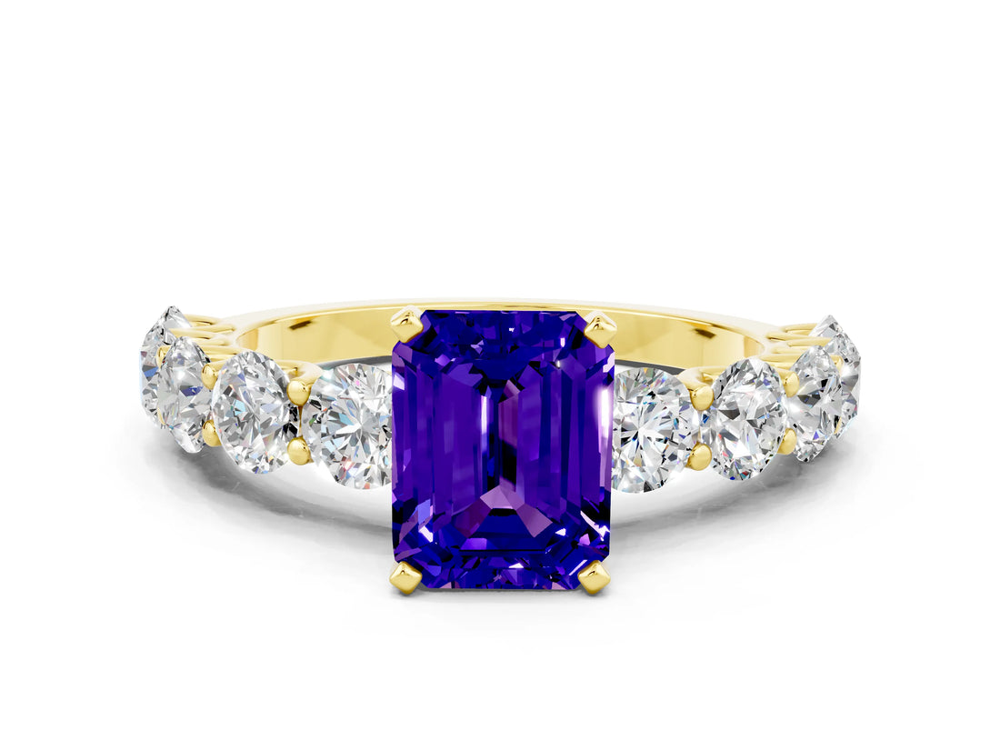 Yellow gold Emerald Cut Tanzanite Prong Setting with Side Stones on a Pave Band