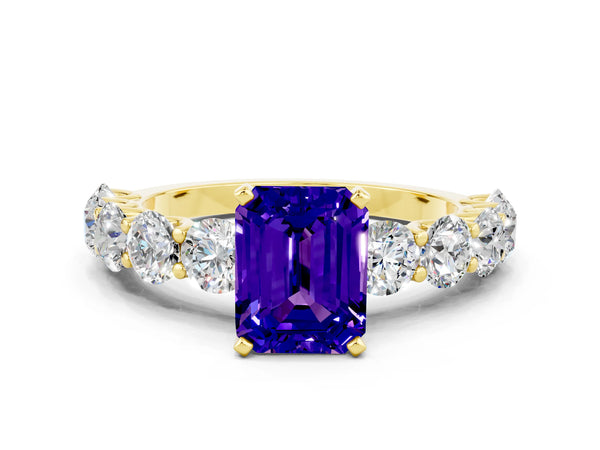 Yellow gold Emerald Cut Tanzanite Prong Setting with Side Stones on a Pave Band