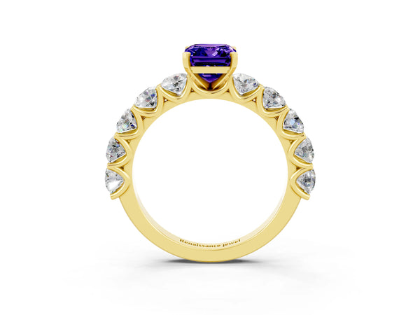 Yellow gold Emerald Cut Tanzanite Prong Setting with Side Stones on a Pave Band