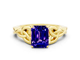 Yellow gold Emerald Cut Tanzanite Solitaire Engagement Ring with Celtic Knot Band and Four-Prong Setting