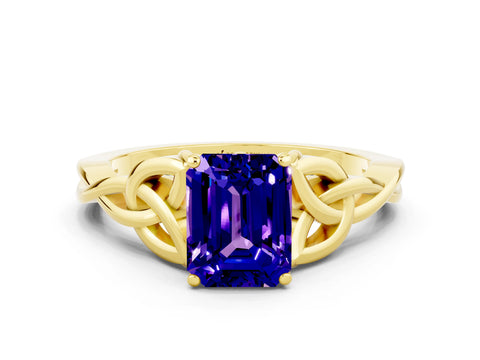 Yellow gold Emerald Cut Tanzanite Solitaire Engagement Ring with Celtic Knot Band and Four-Prong Setting