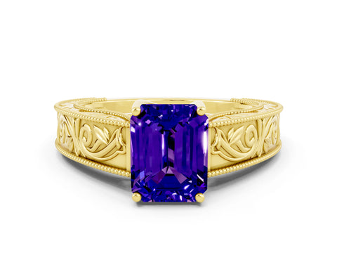 Yellow gold Emerald Cut Tanzanite Solitaire Ring with Engraved Band and Four-Prong Setting