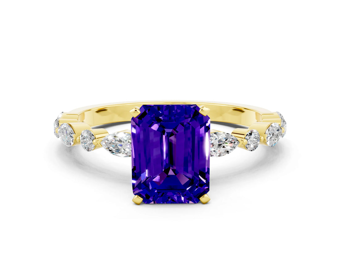 Yellow gold Emerald Cut Tanzanite Solitaire with Side Stones on a Pavé Band and Four-Prong Setting