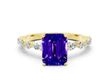 Yellow gold Emerald Cut Tanzanite Solitaire with Side Stones on a Pavé Band and Four-Prong Setting