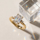Yellow gold Emerald Cut Three-Stone Solitaire Ring with Round Accent Diamonds and Four-Prong Setting_52