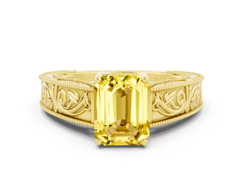 Yellow gold Emerald Cut Yellow Sapphire Solitaire Ring with Engraved Band and Four-Prong Setting