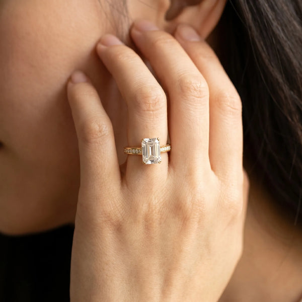 Yellow gold Emerald Diamond Solitaire with Pave Band and Six-Prong Setting