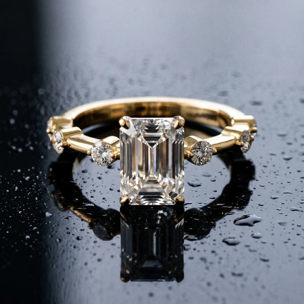 Yellow gold Emerald Solitaire Diamond Ring with Bezel Set Side Stones and Prong Setting