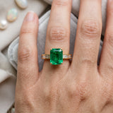 Yellow gold Emerald Solitaire Diamond Ring with Channel-Set Baguette Band and Four-Prong Setting_144