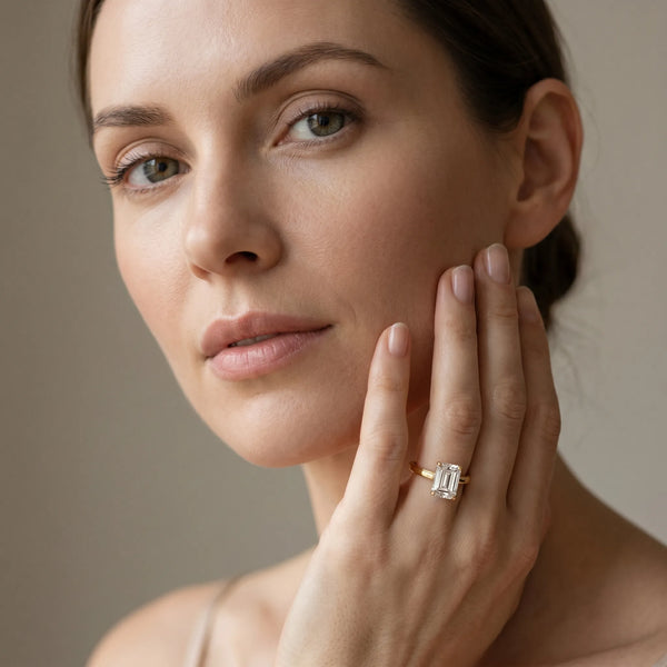 Yellow gold Emerald Solitaire Diamond Ring with Four-Prong Setting and Classic Band