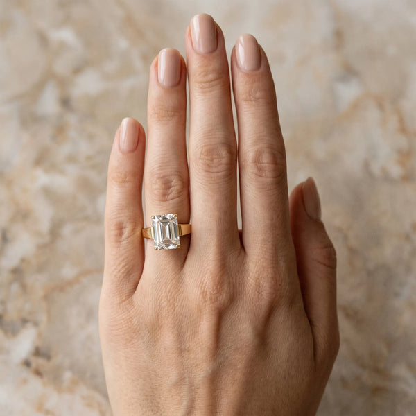 Yellow gold Emerald Solitaire Engagement Ring with Four-Prong Setting and Tapered Band