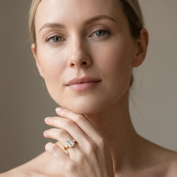 Yellow gold Emerald Solitaire Engagement Ring with Four-Prong Setting and Tapered Band