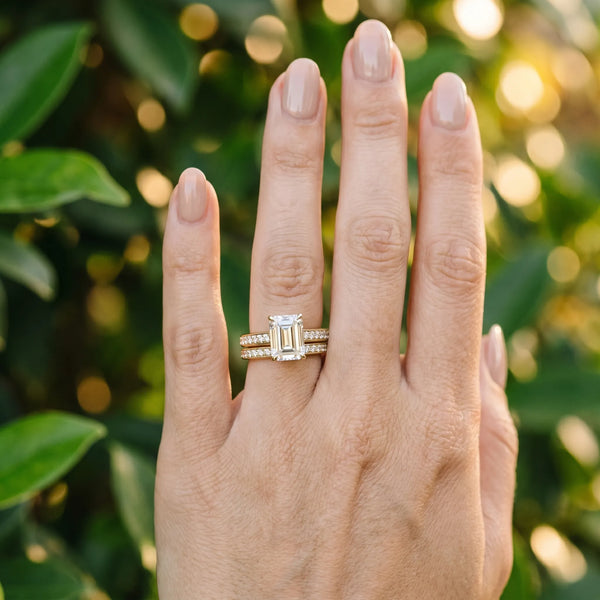 Yellow gold Emerald Solitaire Prong Set Diamond Engagement Ring with Pave Band