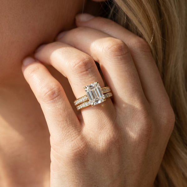 Yellow gold Emerald Solitaire Prong Set Diamond Engagement Ring with Pave Band