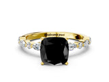 Yellow gold Fancy Black Cushion Cut Diamond Solitaire with Side Stones on a Pavé Band and Four-Prong Setting