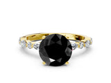 Yellow gold Fancy Black Round Cut Diamond Solitaire with Side Stones on a Pavé Band and Four-Prong Setting
