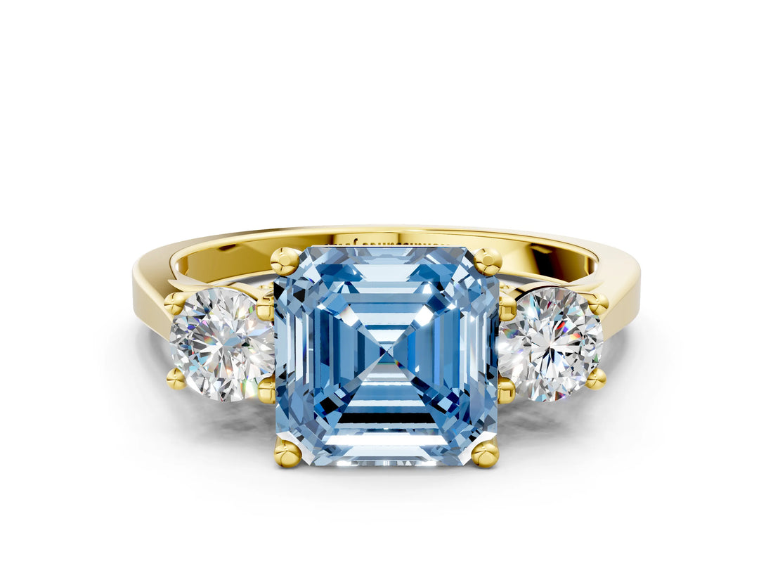 Yellow gold Fancy Blue Asscher Cut Diamond Three-Stone Engagement Ring with Prong Setting and Pavé Band