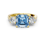 Yellow gold Fancy Blue Asscher Cut Diamond Three-Stone Engagement Ring with Prong Setting and Pavé Band