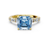 Yellow gold Fancy Blue Asscher  Solitaire with Side Baguettes and Channel Set Band