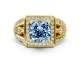 Yellow gold Fancy Blue Cushion Cut Diamond Halo Ring with Split Shank and Bezel Accents and Four-Prong Setting