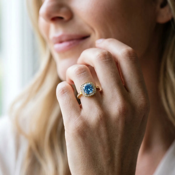 Yellow gold Fancy Blue Cushion Cut Diamond Halo Ring with Split Shank and Four-Prong Setting
