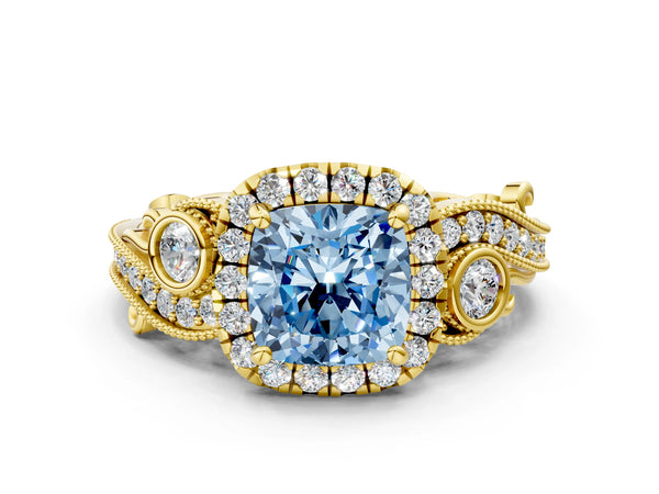 Yellow gold Fancy Blue Cushion Cut Halo Diamond Ring with Milgrain and Bezel Accents on a Split Shank Band