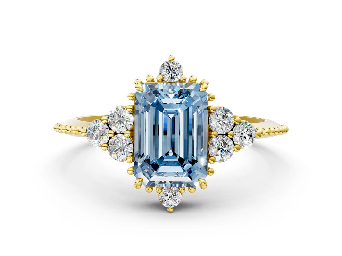Yellow gold Fancy Blue Emerald Cut Brilliant Diamond with Cluster Setting on a Beaded Band and Four-Prong Setting