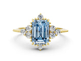 Yellow gold Fancy Blue Emerald Cut Brilliant Diamond with Cluster Setting on a Beaded Band and Four-Prong Setting