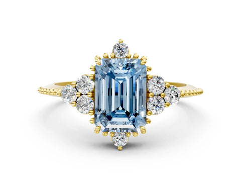 Yellow gold Fancy Blue Emerald Cut Brilliant Diamond with Cluster Setting on a Beaded Band and Four-Prong Setting