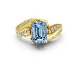 Yellow gold Fancy Blue Emerald Cut Diamond Solitaire Ring with Prong Setting and Twisted Pavé Band