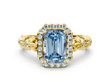 Yellow gold Fancy Blue Emerald Cut Halo Diamond Solitaire with Filigree Band and Four-Prong Setting