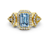Yellow gold Fancy Blue Emerald Cut Halo Diamond Split Shank Engagement Ring with Four-Prong Setting
