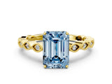 Yellow gold Fancy Blue Emerald Cut Solitaire Diamond Ring with Infinity Twist Band and Four-Prong Setting