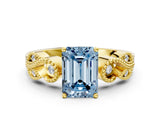 Yellow gold Fancy Blue Emerald Cut Solitaire Milgrain Leaf Band with Prong Setting