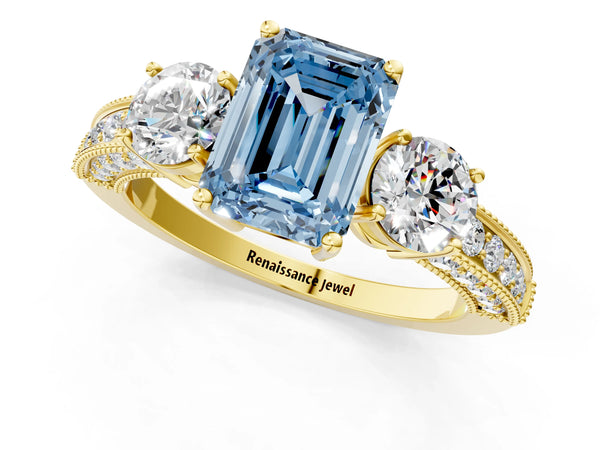 Yellow gold Fancy Blue Emerald Cut Three-Stone Diamond Ring with Pavé Band and Four-Prong Setting