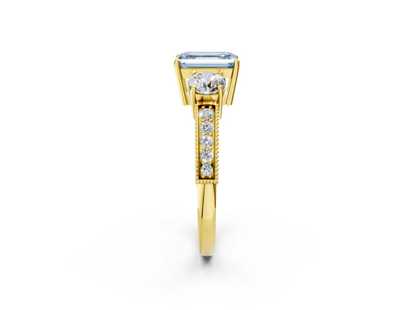 Yellow gold Fancy Blue Emerald Cut Three-Stone Diamond Ring with Pavé Band and Four-Prong Setting